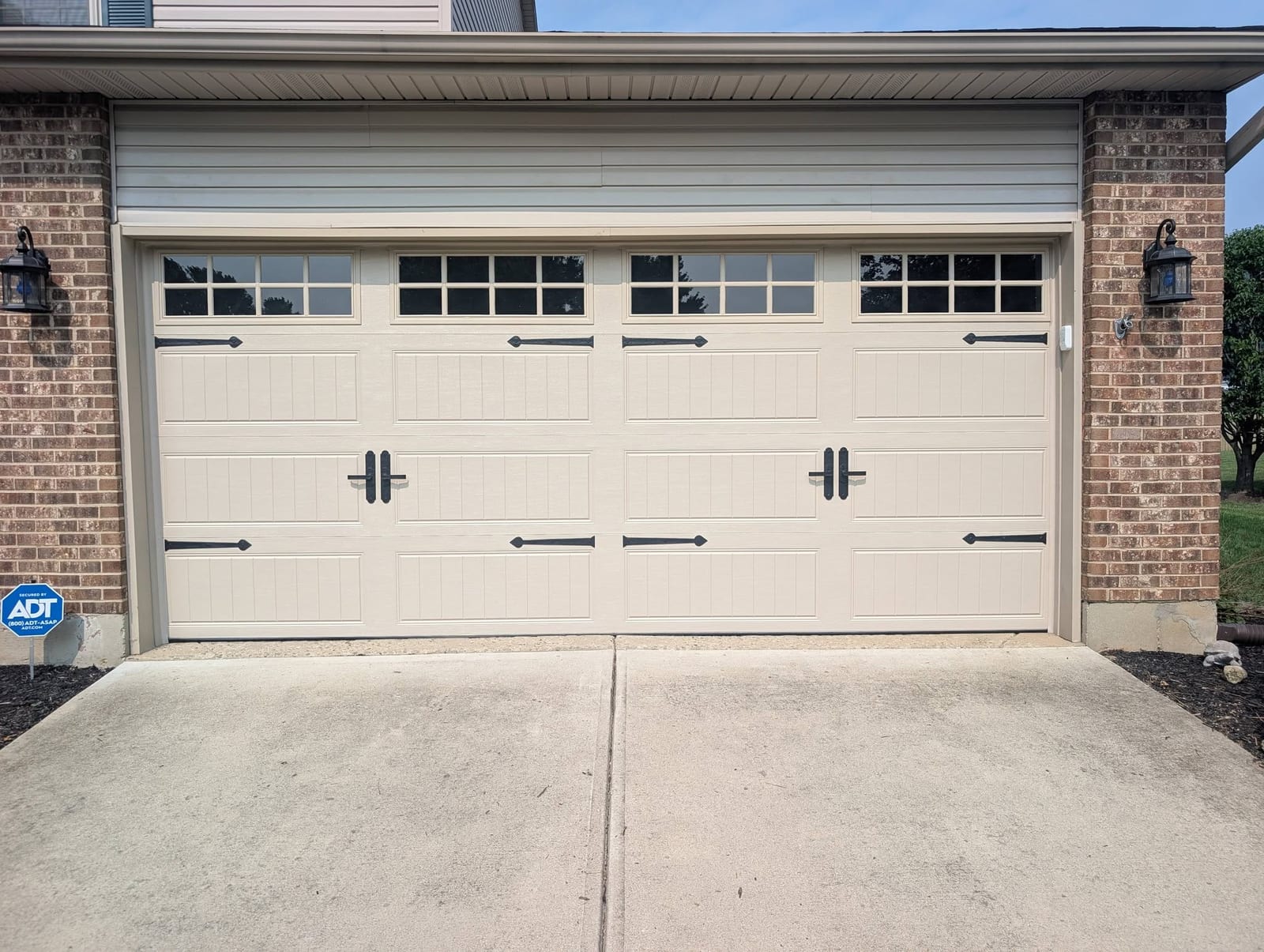Finished carriage-style door on a brick home