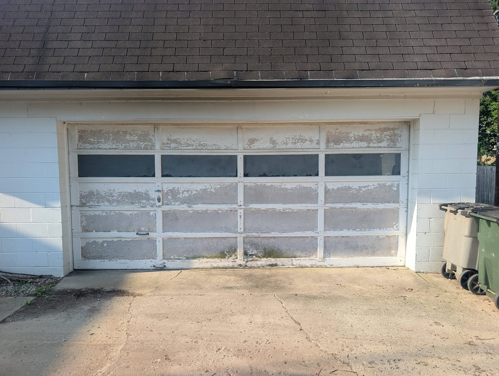 Weathered white garage door before replacement